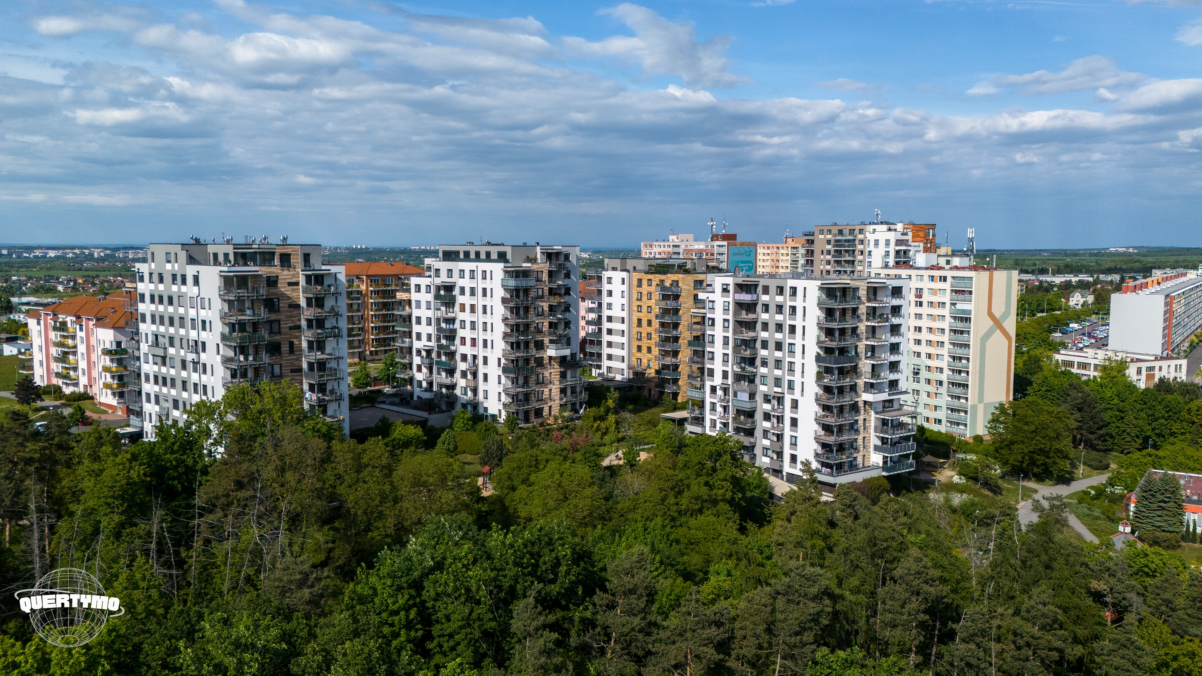 Nadhledová fotografie novostavby s okolní zástavbou